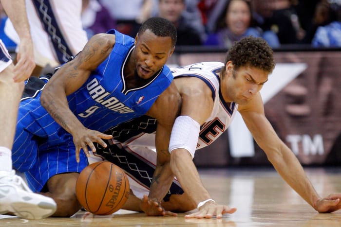 Nov 13, 2010; Newark, NJ, USA; Orlando Magic power forward Rashard Lewis (9) and New Jersey Nets center Brook Lopez (11) battle for loose ball at the Prudential Center. Mandatory Credit: Jim O'Connor